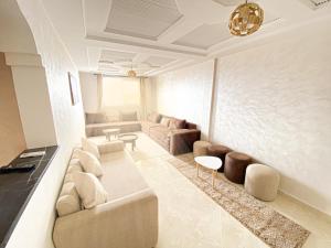 a large living room with couches and a table at Endless Wave Morocco in Agadir