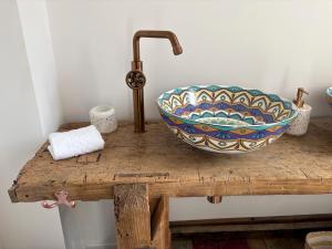 a bathroom counter with a bowl and a sink on it at Chez Fil'O in La Bouille +28 photos