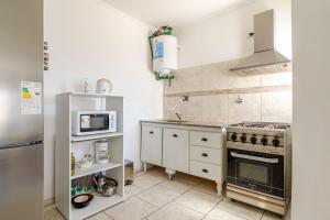 una cocina con estufa y microondas en Tu Casa en San Rafael Centro y Confort, en San Rafael 1 foto más