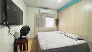 a bedroom with a bed and a flat screen tv at House for COP30 in Cidade Nova for up to 8 People i175 in Ananindeua