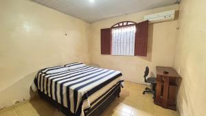 a bedroom with a bed and a desk and a window at House for COP30 in Cidade Nova for up to 8 People i175 in Ananindeua