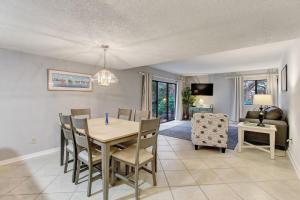 a dining room and living room with a table and chairs at Recently updated 2 bedroom Beachwood Condo 2016 in Franklintown