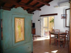 a dining room with a table and a blue cabinet at Le Case Del Vivaio in Sciacca
