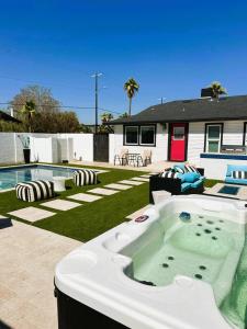 a hot tub in a yard next to a house at Casa Lumina in Phoenix