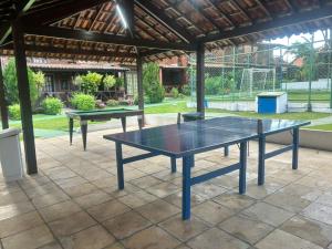 two ping pong tables on a patio at Casa aconchegante e equipada em Gravatá in Gravatá