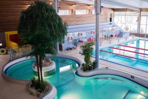a large indoor swimming pool with two pools at Lägenhetshotellet Fridhem in Krylbo