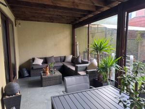 a patio with a couch and chairs on a porch at Nueva casa 6 personas en condominio cerrado in Temuco