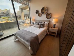 a bedroom with a large bed and a large window at Nauti Baja Condo at The Marina Near the Beach in Cabo San Lucas +29 photos