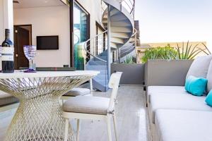 a living room with a table and a couch at Nauti Baja Condo at The Marina Near the Beach in Cabo San Lucas