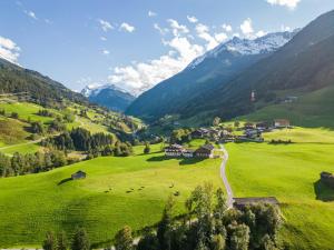 a green valley with a village in the mountains at Mittersill apartment close to ski lifts in Mittersill