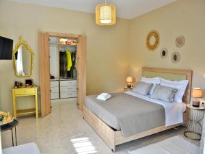 a bedroom with a large bed and a mirror at Elegant Villa with Pool & Garden in Eleousis in Kalithies
