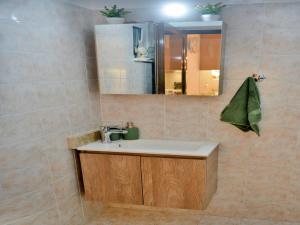 a bathroom with a sink and a mirror at Elegant Villa with Pool & Garden in Eleousis in Kalithies +11 photos