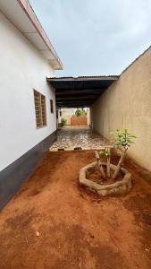a building with a garage with a dirt floor and a plant at Eonka Serviced Homes in Kika +9 photos