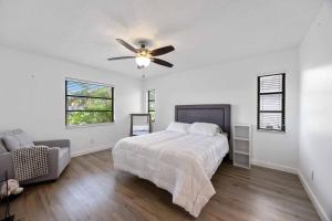 a bedroom with a bed and a ceiling fan at Your Perfect Port Charlotte Retreat in Murdock