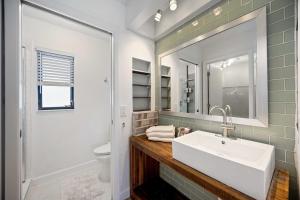 a bathroom with a sink and a mirror at Your Perfect Port Charlotte Retreat in Murdock