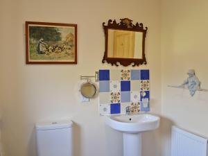 Un baño con inodoro, lavabo y espejo. en Mountain View, en Tomintoul 7 fotos más