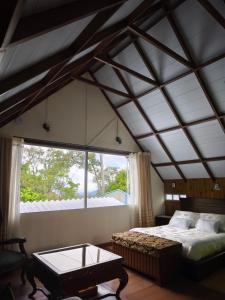 a bedroom with a bed and a large window at Chalet Gardel in San Francisco