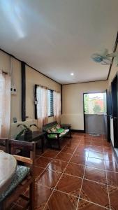 a living room with a large tile floor at Charity Pension House in San Vicente +91 photos