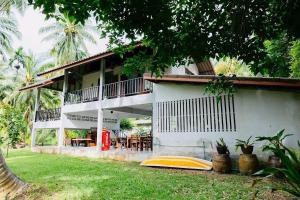 a house with a balcony and a table and chairs at Baan Nai Bang in Suratthani +37 photos