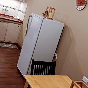 a white refrigerator in a kitchen with a table at Serendipia in Oberá