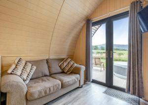 a living room with a couch and a sliding glass door at South View Retreat in Carlton