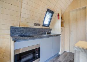 a small kitchen with a sink and a stove at South View Retreat in Carlton +35 photos