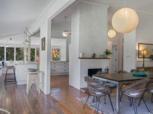 a dining room and kitchen with a table and chairs at Fig Tree House in Teven +21 photos