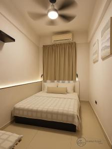 a bedroom with a bed with a ceiling fan at Irama Kopa - Glory Beach Resort in Port Dickson +10 photos