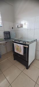 a stove in a kitchen with a towel on it at Exclusive space in the Center, affordable accommodation in Castanhal +3 photos