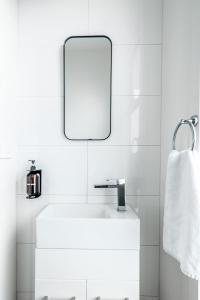 a white bathroom with a sink and a mirror at The Inner-North Escape - Free Parking & Wifi in Melbourne +54 photos