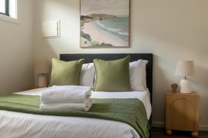 a bedroom with a bed with a towel on it at The Inner-North Escape - Free Parking & Wifi in Melbourne