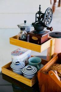 a wooden shelf with dishes and a telephone on it at Baan Nai Bang in Surat Thani +75 photos