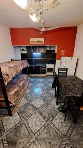 a room with a bed and a table in it at Departamento familiar con pileta exclusiva in Villa Carlos Paz