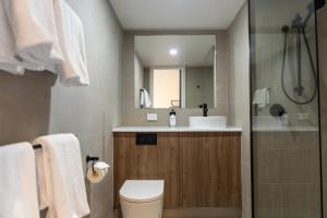 a bathroom with a toilet and a sink and a shower at Black Buffalo in Hobart +17 photos