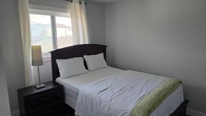 エドモントンにあるHarmony House Edmontonの窓付きのベッドがある小さな寝室