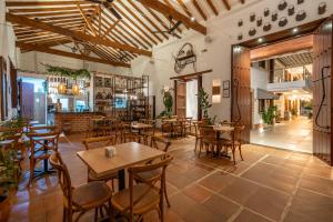 a restaurant with tables and chairs in a room at Casa Bixa Hotel Boutique by HMC - Mayores de 12 años - in Santa Fe de Antioquia
