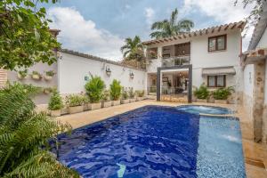 an exterior view of a house with a swimming pool at Casa Bixa Hotel Boutique by HMC - Mayores de 12 años - in Santa Fe de Antioquia