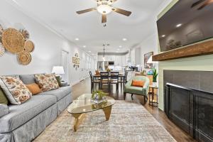 a living room with a couch and a fireplace at Farmville Lakes Tailored Townhouse in Auburn
