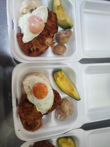 two plastic containers of food with eggs and vegetables at Hospedaje & Restaurante Rancho Grande Tocancipá SAS in Tocancipá +2 photos