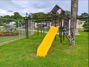 a playground with a yellow slide in a park at Residences Malaga Dream Paradise in Parrita