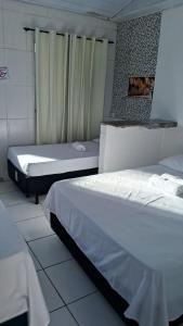 a room with two beds in a room at Pousada Serra Azul in Juquiá +53 photos