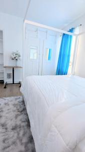 a white bedroom with a large bed and a window at Luxury 2bedrooms 1bath home near philly museum Temple and center city in Philadelphia