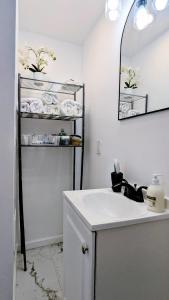 a bathroom with a sink and a shelf with towels at Luxury 2bedrooms 1bath home near philly museum Temple and center city in Philadelphia +30 photos