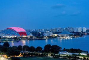 a view of a stadium and a city at night at Hotel Traveltine Downtown Singapore, Trademark Collection in Singapore