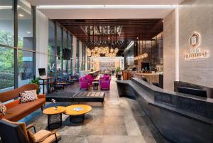 a lobby of a restaurant with couches and tables at Hotel Traveltine Downtown Singapore, Trademark Collection in Singapore