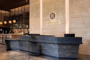 a bar with a sign on the wall of a restaurant at Hotel Traveltine Downtown Singapore, Trademark Collection in Singapore +80 photos