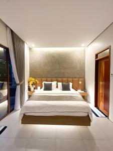 a bedroom with a large bed and a large window at Sakuya Villa 