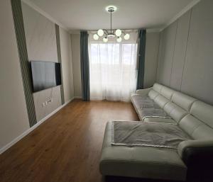 a living room with a couch and a television at Ger buudal Orkhon in Erdenet