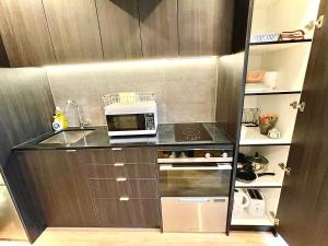 a small kitchen with a microwave on a counter at Modern apartment in the city center in Auckland