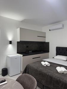 a bedroom with a bed with two towels on it at Apartmani Zabjelo in Podgorica
